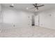 Bright bedroom featuring marble tile floors, a ceiling fan, and neutral walls at 1625 S 113Th Ave, Avondale, AZ 85323