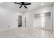Bright bedroom features a ceiling fan, walk-in closet, and marble tile flooring at 1625 S 113Th Ave, Avondale, AZ 85323