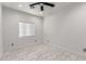Bright bedroom featuring marble tile flooring, a ceiling fan, and a window at 1625 S 113Th Ave, Avondale, AZ 85323