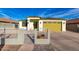 Charming single-story home featuring a well-manicured front yard, decorative fence, and a yellow two-car garage at 1625 S 113Th Ave, Avondale, AZ 85323