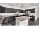 Open kitchen featuring dark cabinets, granite countertops, an island, stainless steel appliances, and recessed lighting at 1625 S 113Th Ave, Avondale, AZ 85323