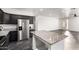 Large open kitchen featuring dark cabinets, gray granite countertops, an island, and stainless steel appliances at 1625 S 113Th Ave, Avondale, AZ 85323