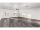 Spacious living room featuring a modern ceiling fan, white walls, a large window, and gray tile flooring at 1625 S 113Th Ave, Avondale, AZ 85323