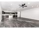 Open-concept living space featuring a kitchen with dark cabinets, gray granite, and an island with gray tile flooring at 1625 S 113Th Ave, Avondale, AZ 85323