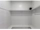 A clean, bright walk-in closet with shelving and tile flooring at 1625 S 113Th Ave, Avondale, AZ 85323