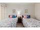 Well-lit bedroom featuring twin beds with floral linens and coordinated decor at 1651 E Borghese Pl, Phoenix, AZ 85016