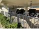 Outdoor patio area with tables, chairs and grill covered by a shaded roof and manicured shrubbery at 1651 E Borghese Pl, Phoenix, AZ 85016