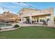 Inviting backyard featuring a pool, covered patio, and lush artificial turf at 16825 S 12Th Way, Phoenix, AZ 85048