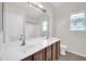 Bathroom featuring a double sink vanity and large mirror at 17388 W Elaine Dr, Goodyear, AZ 85338