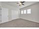 This bedroom features carpeted floors, a ceiling fan, and a closet at 17388 W Elaine Dr, Goodyear, AZ 85338