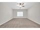 Bedroom with ceiling fan, plush carpet, and natural light at 17388 W Elaine Dr, Goodyear, AZ 85338