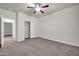 This bedroom features carpet, a ceiling fan, and a closet at 17388 W Elaine Dr, Goodyear, AZ 85338
