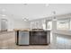 Kitchen island with bar seating, stainless steel appliances, and a double sink at 17388 W Elaine Dr, Goodyear, AZ 85338