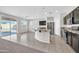 Open concept kitchen with a large island, tile floor, and stainless appliances at 17388 W Elaine Dr, Goodyear, AZ 85338