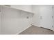 Neutral laundry room with built-in shelf and tile flooring at 17388 W Elaine Dr, Goodyear, AZ 85338