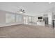 Expansive living area showcasing an open layout with a kitchen island and sliding door access at 17388 W Elaine Dr, Goodyear, AZ 85338