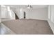 Spacious living area with staircase, tile flooring and neutral walls at 17388 W Elaine Dr, Goodyear, AZ 85338