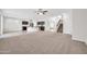Open-concept living area connecting the living room, kitchen, and staircase, with neutral tones at 17388 W Elaine Dr, Goodyear, AZ 85338