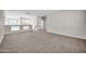 Open loft with neutral carpet, staircase and view of the front entryway at 17388 W Elaine Dr, Goodyear, AZ 85338