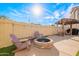 Enjoy a backyard with string lights, pavers, artificial grass, a pergola, and outdoor seating around a firepit at 17722 N 183Rd Ave, Surprise, AZ 85374