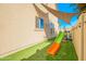 A view of the backyard with a slide and artificial turf at 17722 N 183Rd Ave, Surprise, AZ 85374