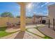 Inviting backyard with a fire pit, covered patio, and artificial turf at 17722 N 183Rd Ave, Surprise, AZ 85374