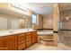 Luxurious bathroom with dual sinks, a soaking tub, and a glass-enclosed shower at 17722 N 183Rd Ave, Surprise, AZ 85374