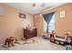 Cozy bedroom with neutral walls, a ceiling fan, and playful decor for a  at 17722 N 183Rd Ave, Surprise, AZ 85374