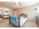 Charming bedroom with a ceiling fan, a crib, and a closet with mirrored doors at 17722 N 183Rd Ave, Surprise, AZ 85374