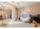Neutral-toned bedroom with a ceiling fan, crib, and mirrored closet doors at 17722 N 183Rd Ave, Surprise, AZ 85374