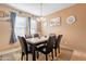 Elegant dining room with a marble-top table, six chairs, and a decorative pendant light at 17722 N 183Rd Ave, Surprise, AZ 85374