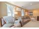 Inviting living room area, with comfortable seating, carpet flooring, and bright windows with a large sofa at 17722 N 183Rd Ave, Surprise, AZ 85374