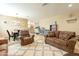 Cozy living room featuring comfortable seating, a patterned rug, and an adjacent dining area at 17722 N 183Rd Ave, Surprise, AZ 85374