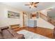 Comfortable living room featuring hardwood floors, a cozy rug, and a staircase to the upper level at 17722 N 183Rd Ave, Surprise, AZ 85374
