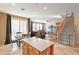 Open living space with a kitchen island, dining table, and staircase to the second floor at 17722 N 183Rd Ave, Surprise, AZ 85374