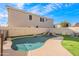Backyard pool features a rock waterfall, artificial turf and lovely desert landscaping at 17722 N 183Rd Ave, Surprise, AZ 85374