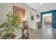 Cozy foyer with stylish decor, house plant, and view into dining room provides a warm and welcoming atmosphere at 17807 N 126Th Dr, Sun City West, AZ 85375