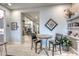 Bright dining area featuring tiled floors, stylish wall decor, and access to other rooms at 18207 W Hope Dr, Goodyear, AZ 85338