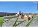 Backyard with a paver patio, outdoor fireplace, decorative plantings and privacy wall at 18429 W Mohave St, Goodyear, AZ 85338