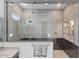 Contemporary shower showcasing glass and ceramic tile, brass fixtures, and built-in shelving at 18429 W Mohave St, Goodyear, AZ 85338