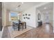Bright dining room featuring modern decor, a contemporary chandelier and wood-look flooring at 18429 W Mohave St, Goodyear, AZ 85338