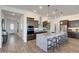 Beautiful kitchen with a large island with barstool seating, stainless steel appliances, and pendant lighting at 18429 W Mohave St, Goodyear, AZ 85338