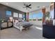 Serene main bedroom with a dark accent wall, carpeted flooring, and ample natural light from the large windows at 18429 W Mohave St, Goodyear, AZ 85338