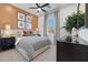 Tranquil main bedroom with a stylish bed, and a large window with sheer curtains at 18429 W Mohave St, Goodyear, AZ 85338
