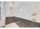 Close up of a shower with glass and ceramic tile, brass fixtures, and built-in shelving at 18429 W Mohave St, Goodyear, AZ 85338