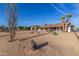 Expansive backyard area with desert landscaping and views of the home's exterior at 18630 N Palo Verde Dr, Sun City, AZ 85373