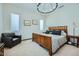 Bright bedroom with a chandelier, neutral decor, and comfortable bed, creating a serene and relaxing atmosphere at 19140 N 259Th Ave, Buckeye, AZ 85396