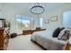 Bright bedroom with a large window, chandelier, and comfortable furnishings, creating a relaxing and inviting space at 19140 N 259Th Ave, Buckeye, AZ 85396