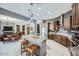 Spacious kitchen with a central island, dark wood cabinets, and seamless access to the living area at 19140 N 259Th Ave, Buckeye, AZ 85396