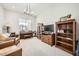 Bright living room featuring a piano, built-in shelving, and a comfortable leather chair, creating an inviting space at 19140 N 259Th Ave, Buckeye, AZ 85396